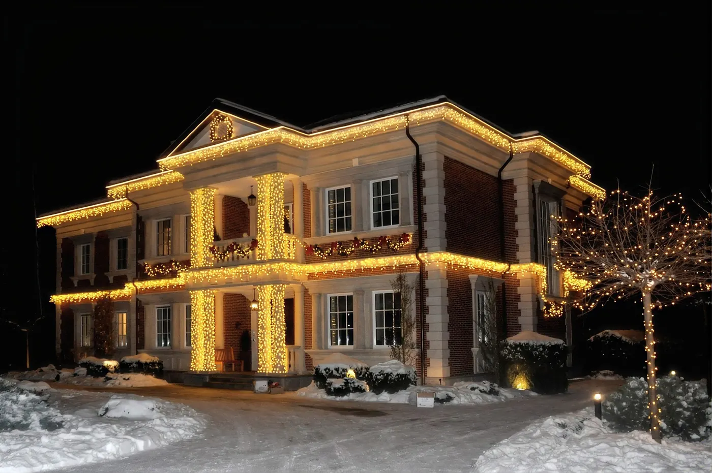 Modern home outlined in warm white lights